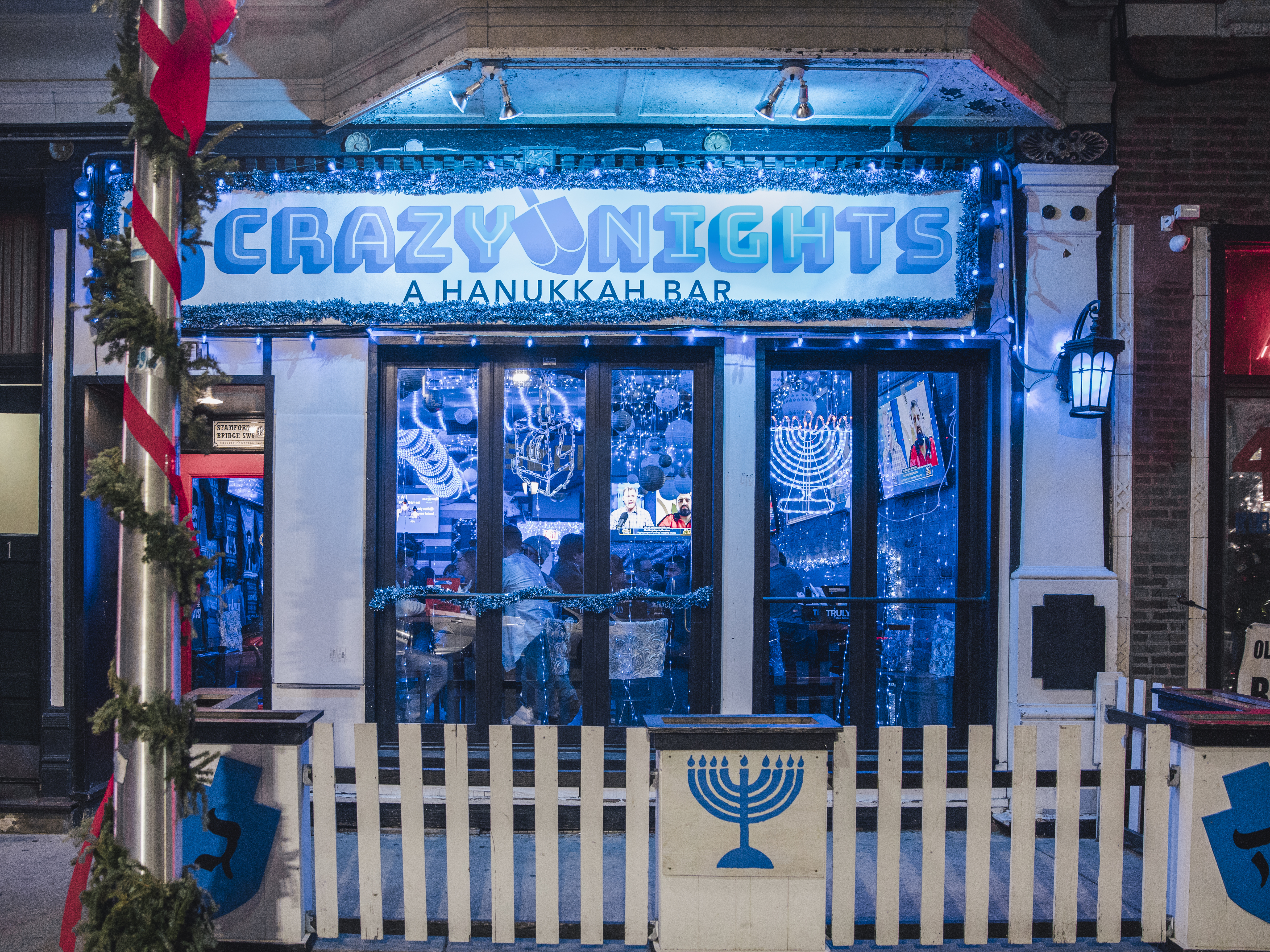 caption: Façade of Chicago's first and only Hanukkah-themed pop-up bar in Wrigleyville.