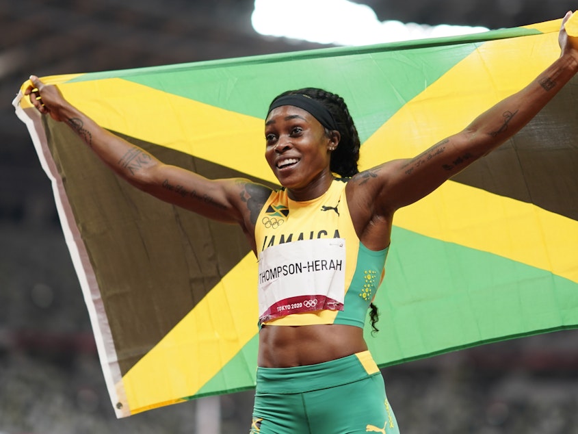 caption: Elaine Thompson-Herah, of Jamaica, reacts after winning the final of the women's 200-meters at the 2020 Summer Olympics, Tuesday, Aug. 3, 2021, in Tokyo.