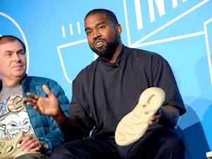 caption: Steven Smith and Kanye West speak on stage at the "Kanye West and Steven Smith in Conversation with Mark Wilson" on Nov. 7, 2019, in New York City.