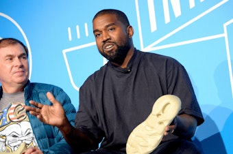 caption: Steven Smith and Kanye West speak on stage at the "Kanye West and Steven Smith in Conversation with Mark Wilson" on Nov. 7, 2019, in New York City.