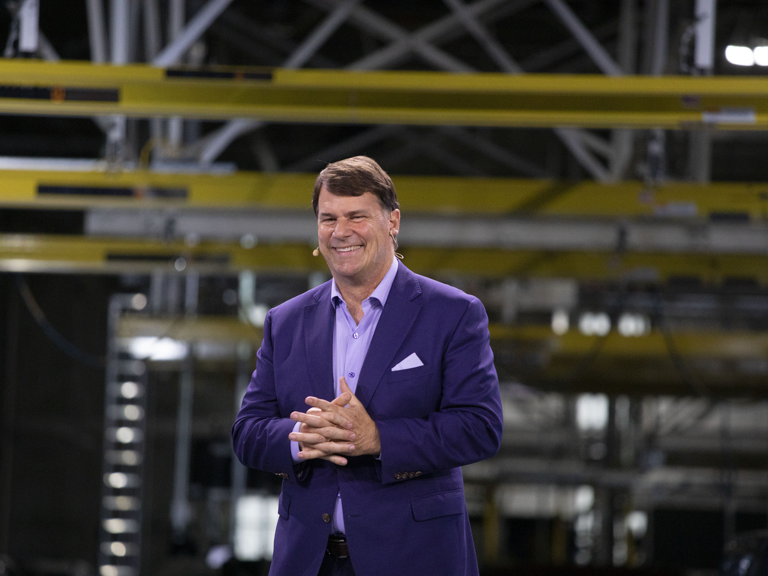 caption: Ford CEO Jim Farley speaks at the launch of the Ford F-150 Lightning at the Ford Rouge Electric Vehicle Center in Dearborn, Mich., on April 26, 2022. Farley is determined to expand production of electric cars — and at the same time, to make more energy-efficient gas-powered and hybrid models.