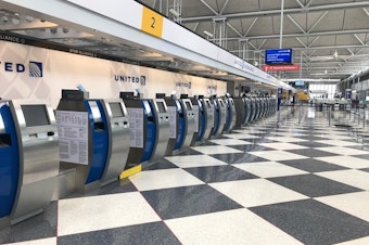 caption: An empty terminal at Chicago's O'Hare International Airport. The normally bustling check-in at the United Airlines terminal was eerily quiet on April 24.