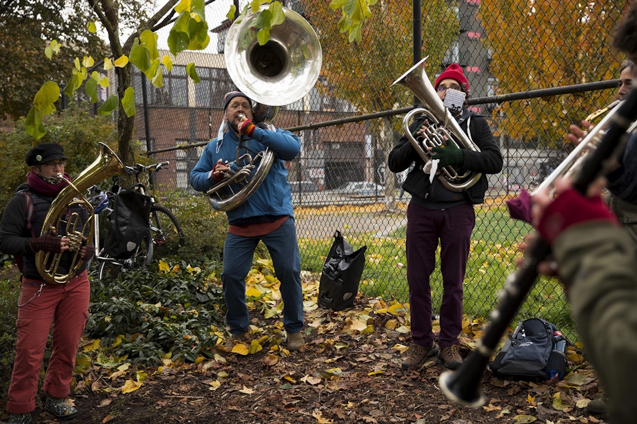 caption: A band performs during an impromptu celebration after Joe Biden was officially named the president elect on Saturday, November 7, 2020, at the intersection of 10th Avenue and East Pine Street in Seattle.