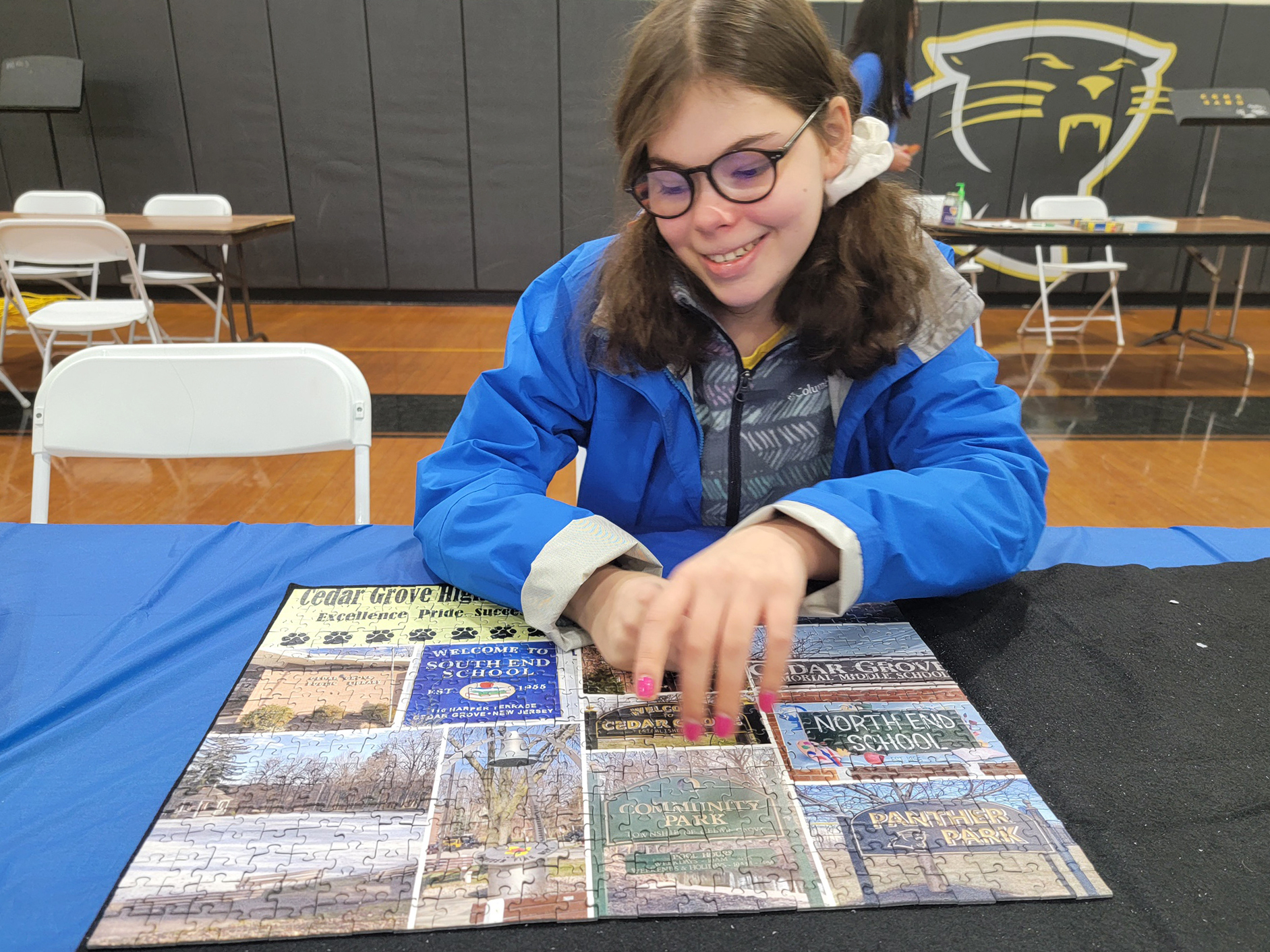 caption: Mora Leeb places some pieces into a puzzle during a local puzzle tournament. The 15-year-old has grown up without the left side of her brain after it was removed when she was very young.