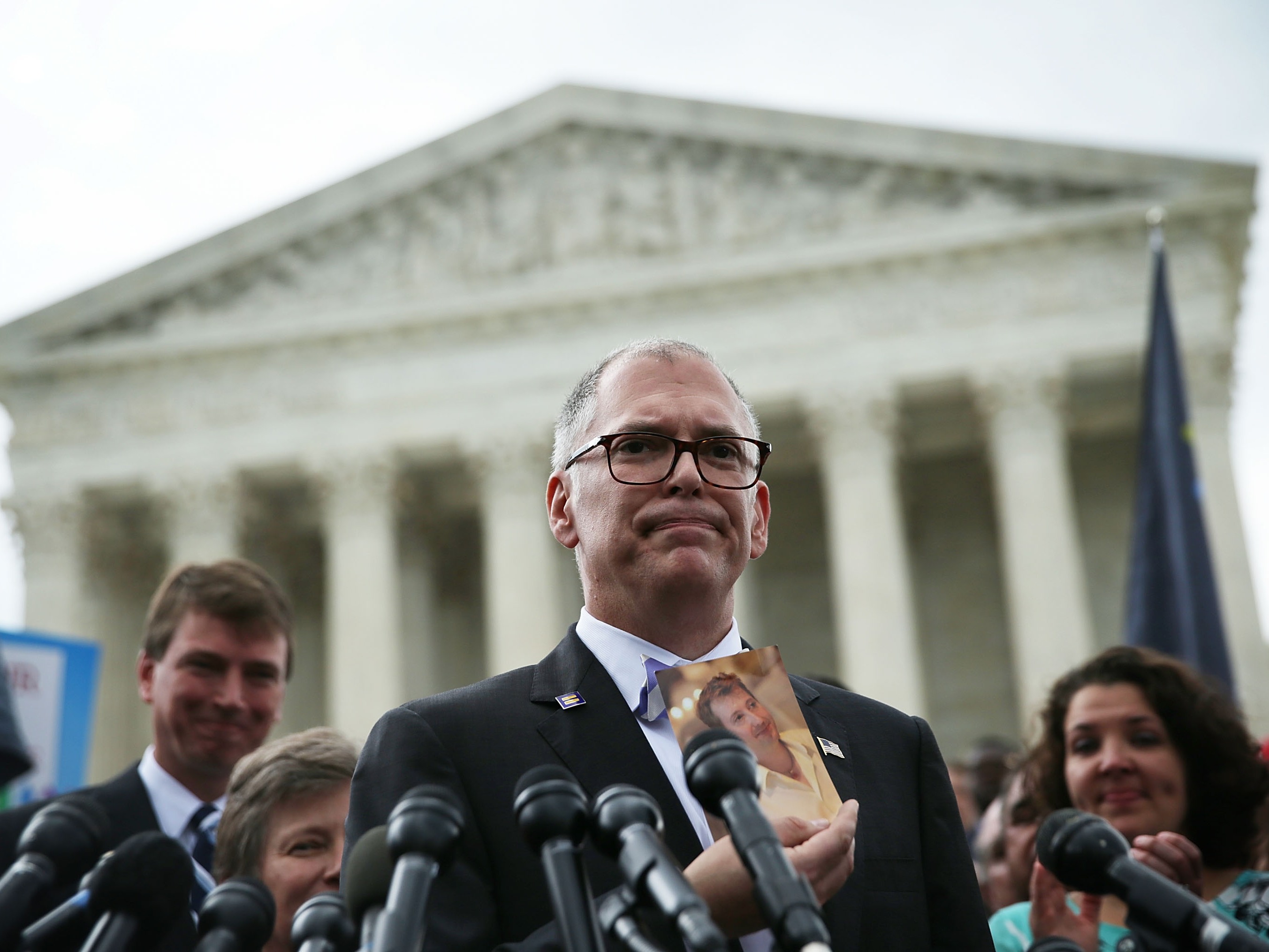 caption: Plaintiff Jim Obergefell holds a photo of his late husband John Arthur as he speaks to members of the media after the U.S. Supreme Court handed down a ruling regarding same-sex marriage June 26, 2015 outside the Supreme Court in Washington, DC. The high court ruled that same-sex couples have the right to marry in all 50 states.