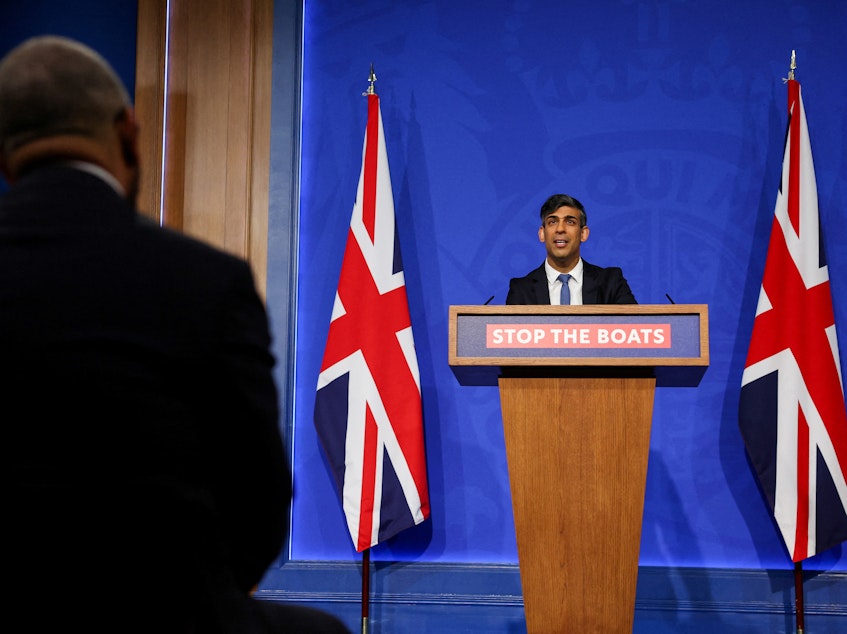 caption: British Prime Minister Rishi Sunak speaks during a press conference in London on Monday regarding a treaty between Britain and Rwanda to transfer asylum-seekers to the African country.