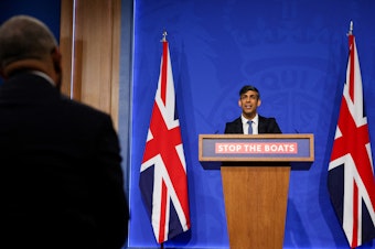 caption: British Prime Minister Rishi Sunak speaks during a press conference in London on Monday regarding a treaty between Britain and Rwanda to transfer asylum-seekers to the African country.