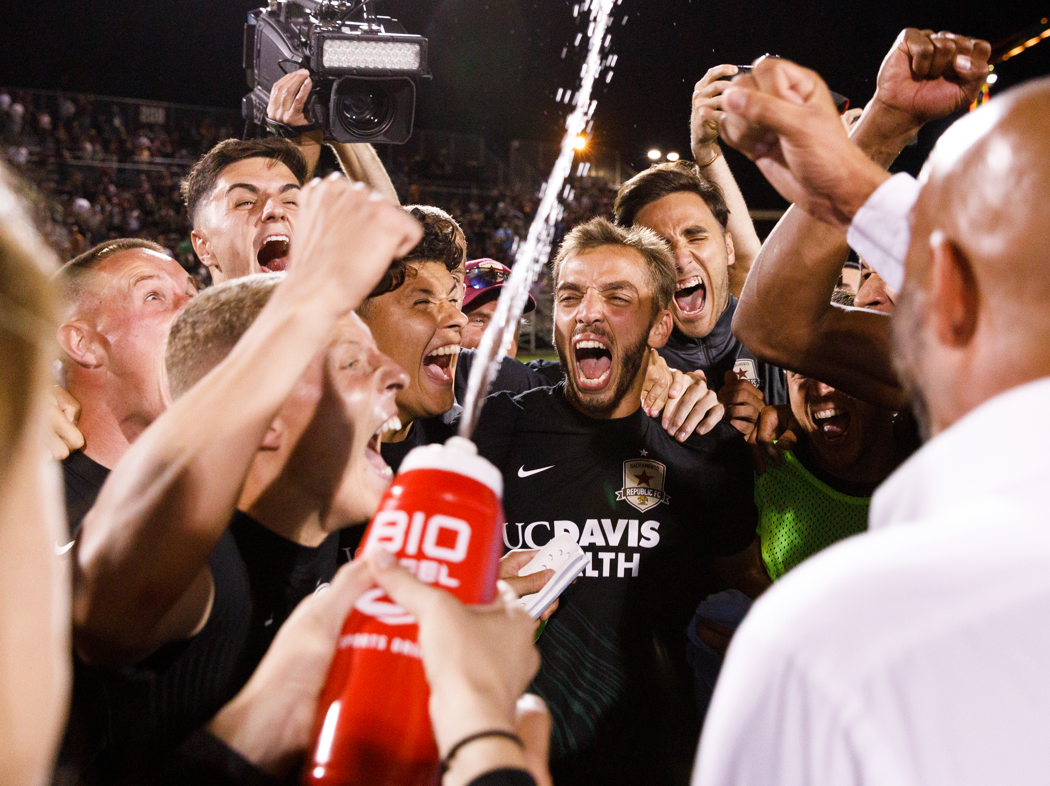 caption: Sacramento Republic FC Players celebrate their U.S. Open semifinal overtime win. Sac Republic defeated MLS mainstay Sporting KC 5-4 in penalty kicks.