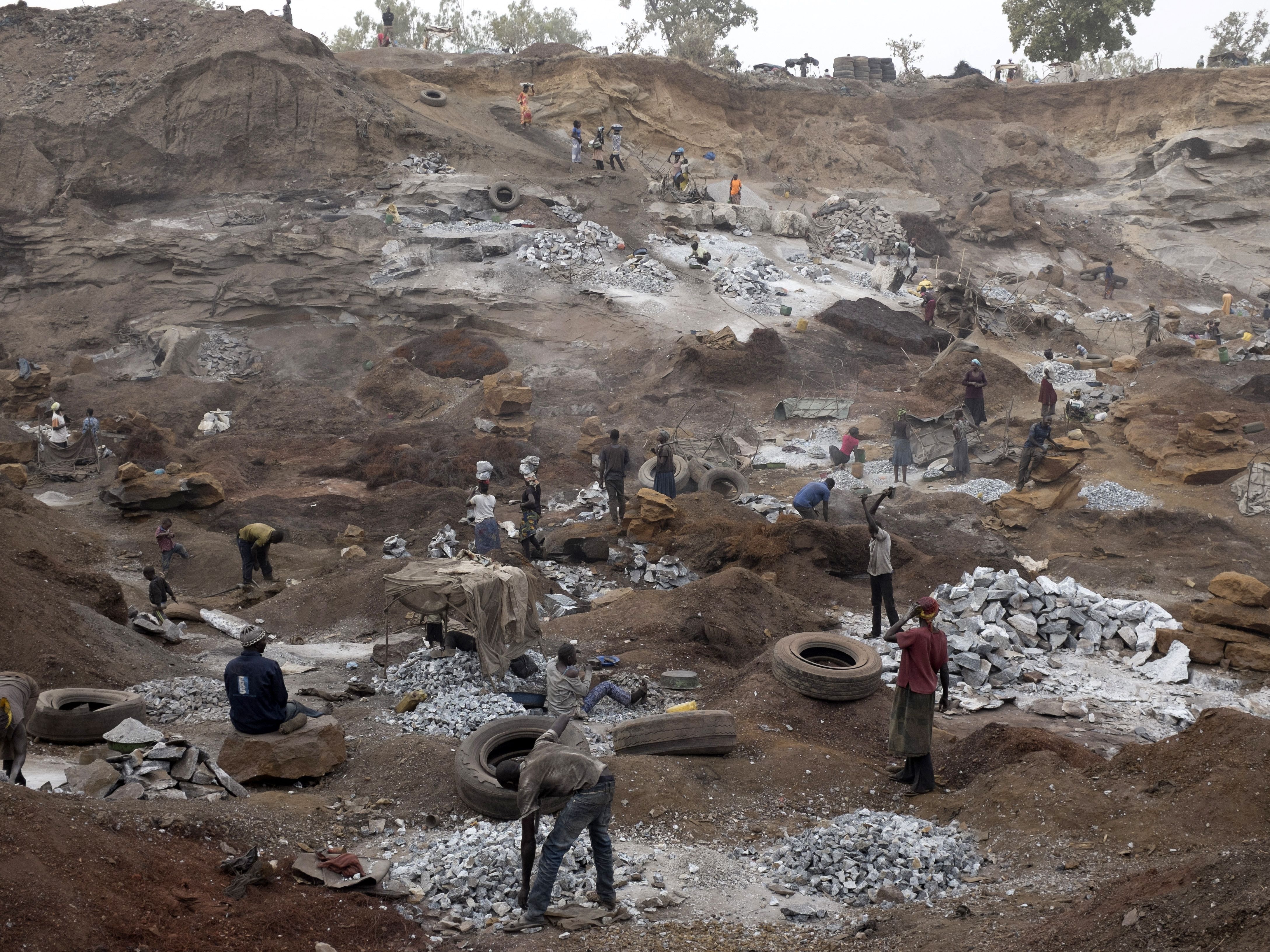caption: Children work alongside adults in a quarry in Ouagadougou, the largest city in Burkina Faso.