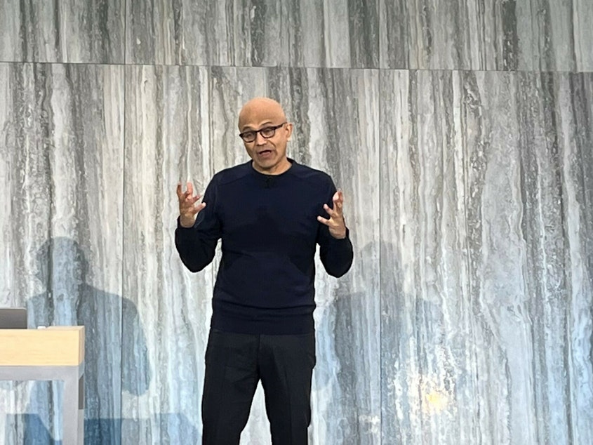 caption: Microsoft CEO Satya Nadella presenting at the company's headquarters in Redmond, Washington.