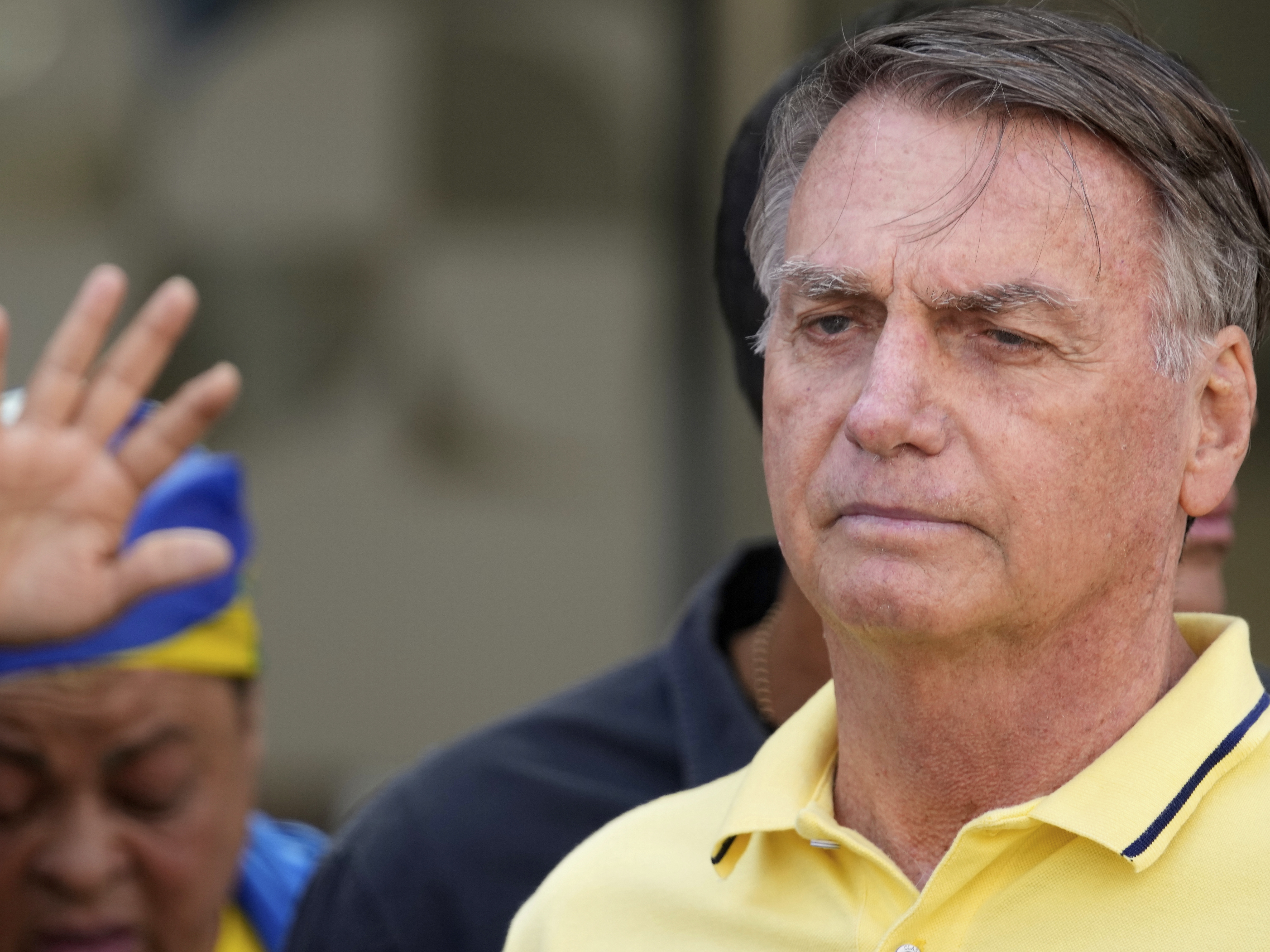 caption: Brazil's former President Jair Bolsonaro, temporarily allowed out of house arrest for medical exams, leaves a hospital in Brasília, Brazil, Saturday, Aug. 16, 2025. (AP Photo/Eraldo Peres)