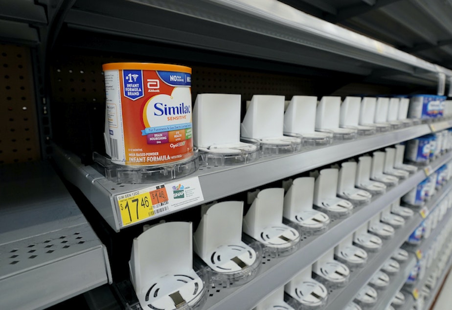 caption: Shelves typically stocked with baby formula sit mostly empty at a store in San Antonio, Tuesday, May 10, 2022.