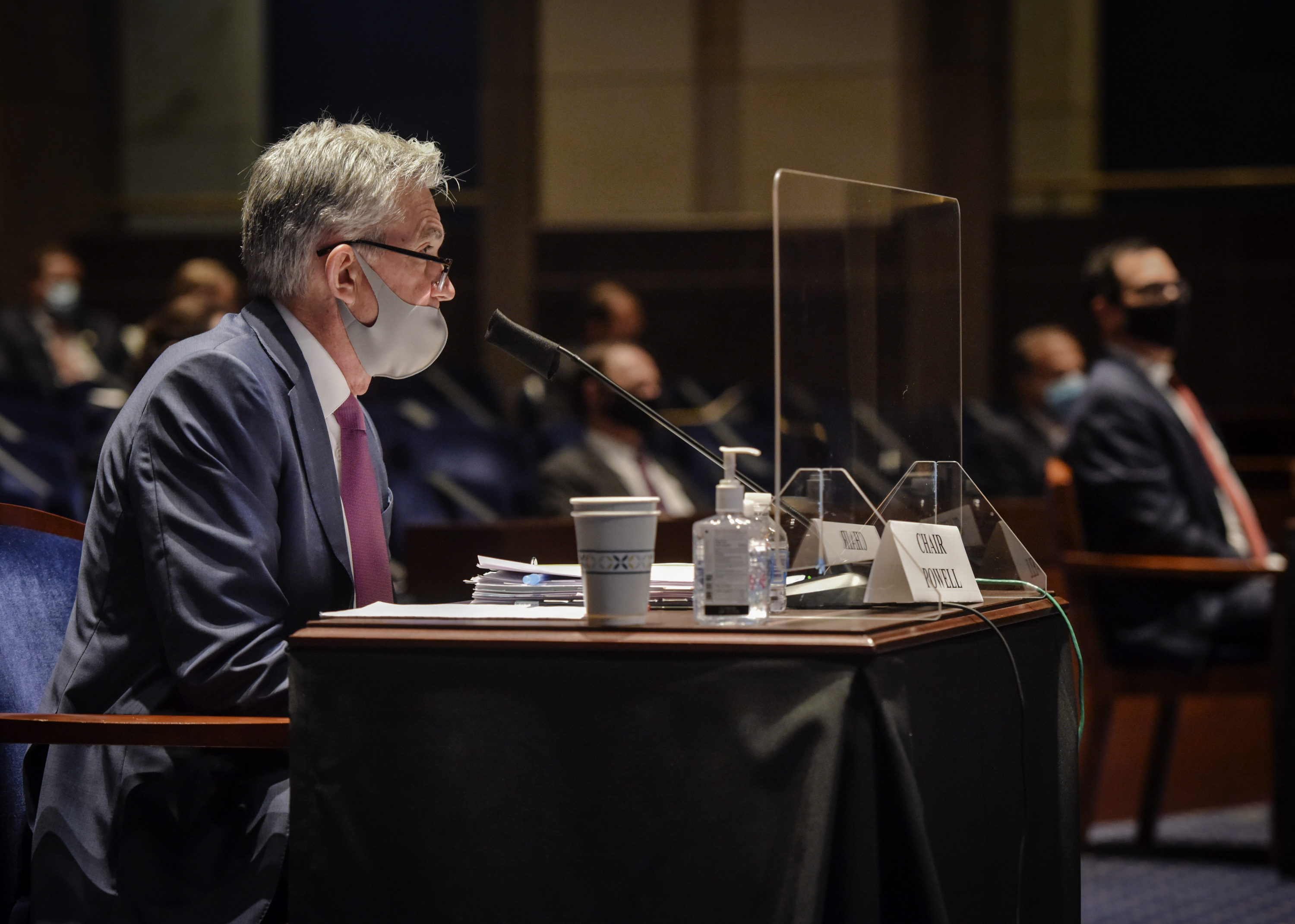 caption: Fed Chairman Jerome Powell (L) and Treasury Secretary Steven Mnuchin (R) appear before the House Committee on Financial Services for a hearing on oversight of the Treasury Department and the Federal Reserve's pandemic response on June 30, 2020. (Bill O'Leary/Pool/Getty Images)