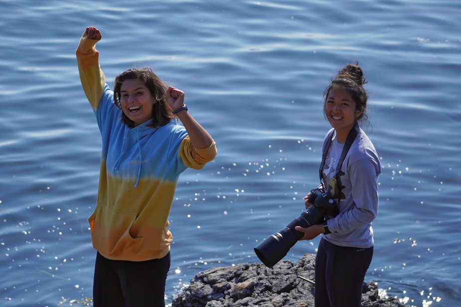 caption: Oceans Initiative researcher Andrea Mendez-Bye (L) and Catherine Lo celebrate the successful deployment of an underwater microphone off the west side of San Juan 
Island. 