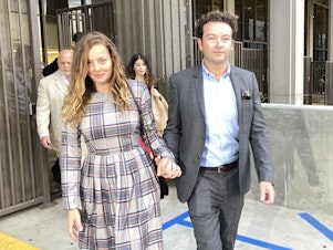 caption: Actor Danny Masterson leaves Los Angeles superior Court with his wife Bijou Phillips after a judge declared a mistrial in his rape case in 2022.