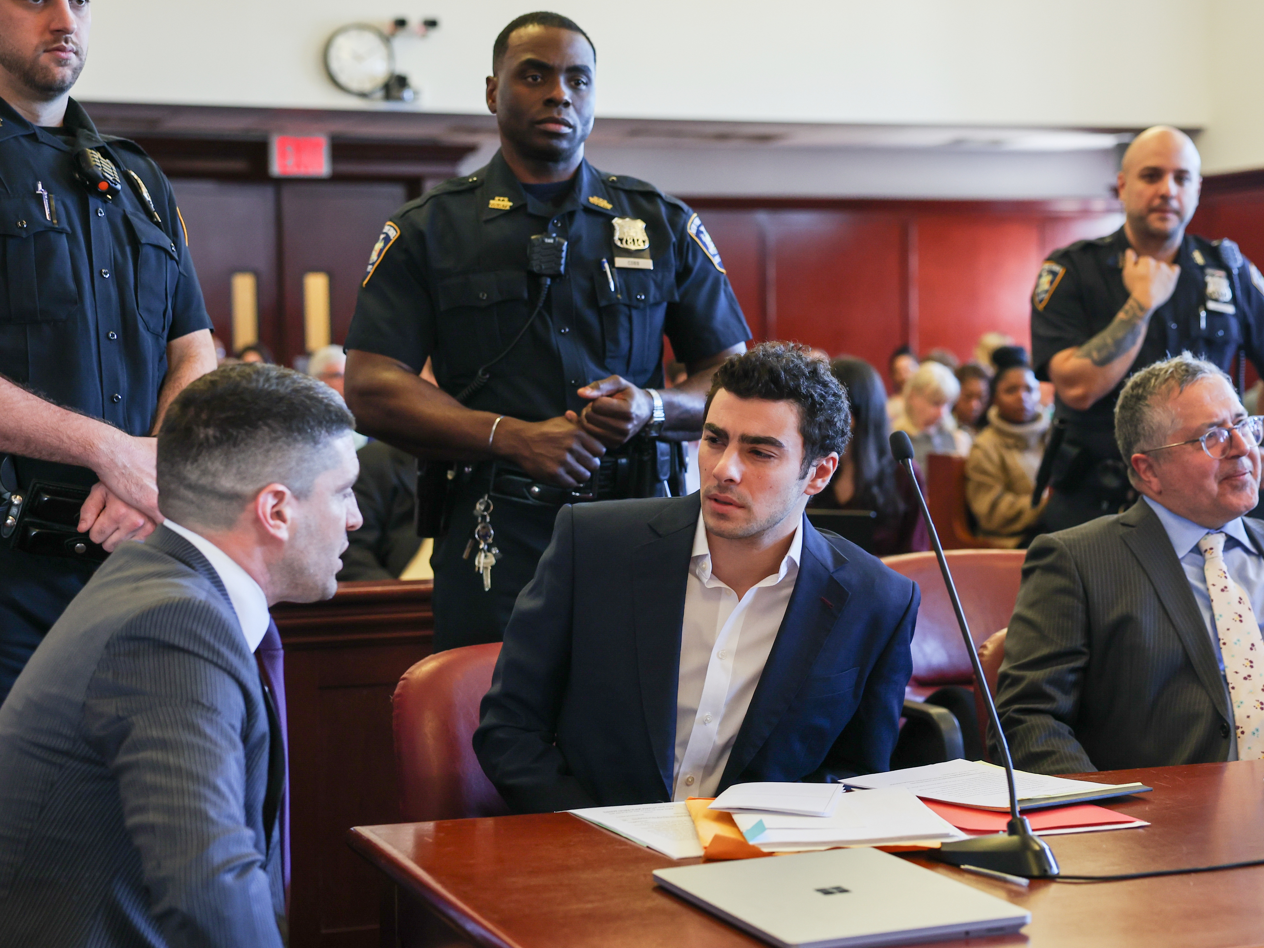 caption: FILE - Luigi Mangione appears in Manhattan Criminal Court for an evidence hearing, Dec. 18, 2025, in New York.