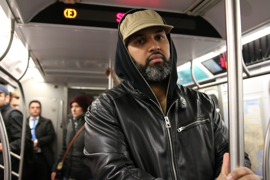 caption: Junior Maglori on the E Line from Queens to Manhattan