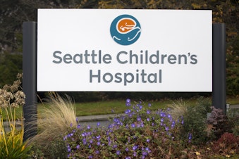 caption: An entrance sign for Seattle Children's Hospital is shown on Thursday, November 14, 2019, in Seattle. 