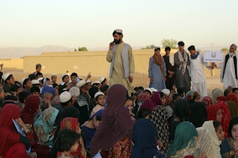 caption: Matiullah Wesa, a girls' education advocate, reads to students in Spin Boldak district in Kandahar province of Afghanistan on May 21, 2022. The Taliban have freed the Afghan activist who campaigned for the education of girls, a local nonprofit organization said Thursday. Wesa was arrested seven months ago and spent 215 days in prison, according to the group, Pen Path.