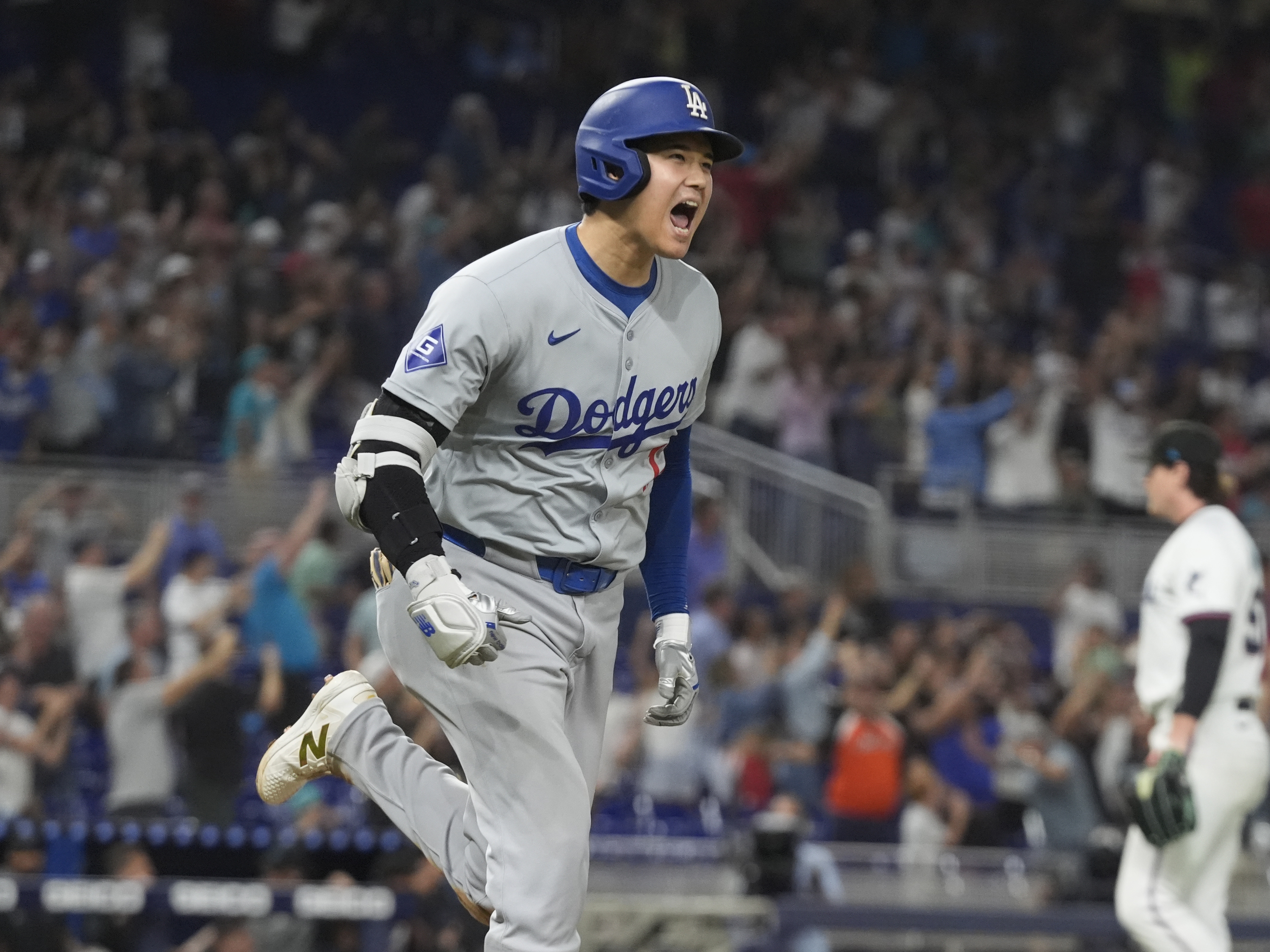 caption: Los Angeles Dodgers' Shohei Ohtani hit his 50th homerun of the season during the seventh inning of a baseball game against the Miami Marlins on Sept. 19 in Miami.