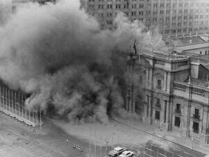 caption: Military jets bombed La Moneda presidential palace during the coup on Sept. 11, 1973, in Santiago, Chile. President Salvador Allende killed himself and Gen. Augusto Pinochet began a 17-year dictatorship.