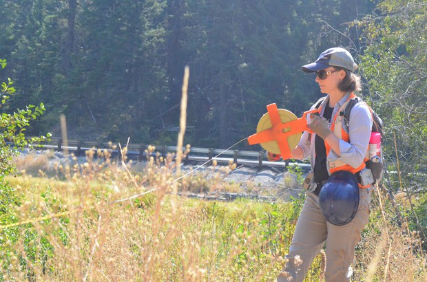 caption: <p>Rebecca Wassel, a biologist who helped design the project,&nbsp;helps mark where the creek is going to run after the culvert gets replaced.</p>