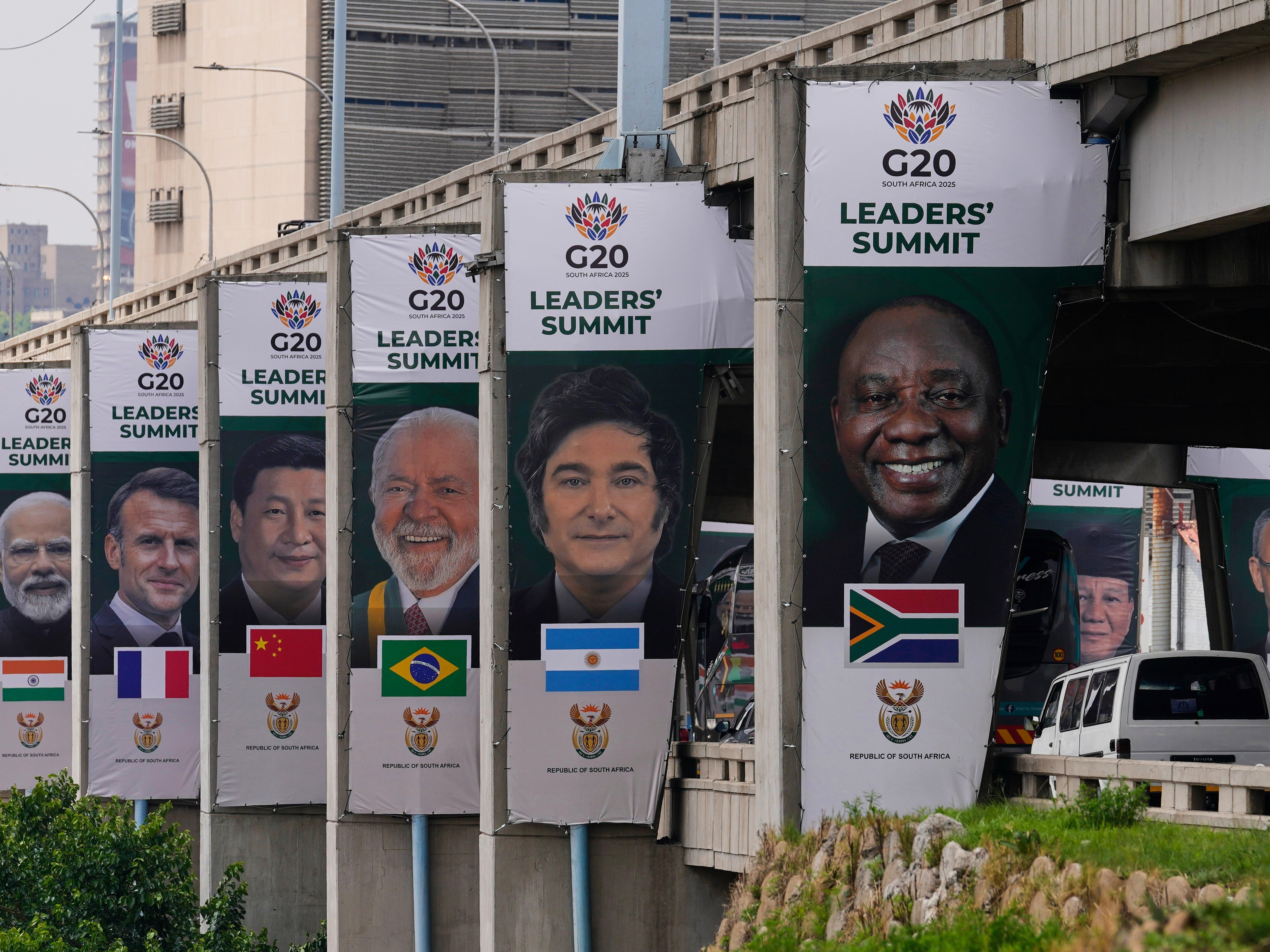 caption: Banners of various G20 leaders are displayed along a Johannesburg freeway, in Johannesburg, South Africa, Thursday, Nov. 20, 2025.