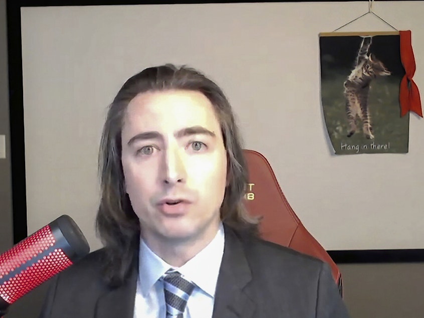 caption: Keith Gill, known as "Roaring Kitty" online, testifies during a virtual hearing on GameStop before the House Financial Services Committee on Feb. 18, 2021. On Monday, Gill made his first online posting on X in about three years, sending shares of GameStop sharply higher.