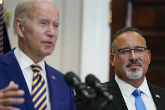 caption: U.S. Education Secretary Miguel Cardona appeared alongside President Biden when he announced his student loan relief plan on Aug. 24. On Thursday, the administration quietly changed its guidance around which borrowers qualify for this relief.