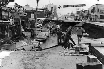 caption: Alaska Earthquake March 27, 1964. Collapse of Fourth Avenue near C Street in Anchorage due to a landslide caused by the earthquake.