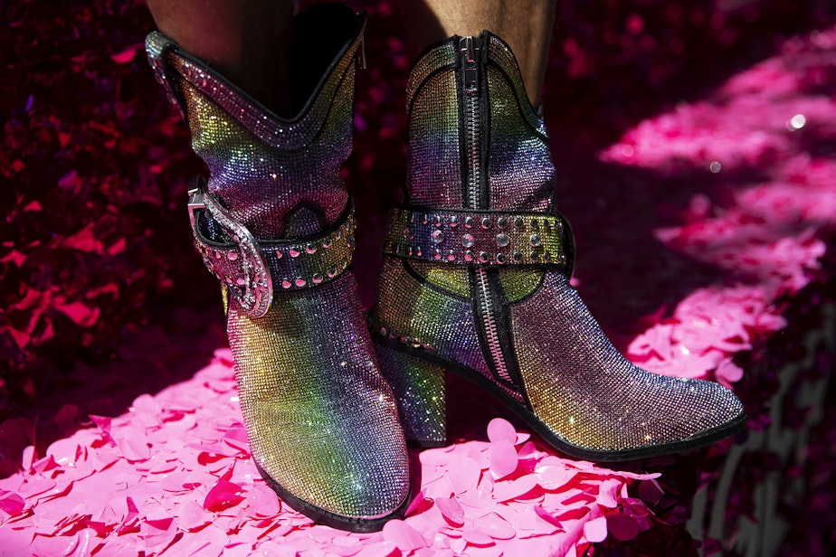 caption: Thousands gathered for the Seattle Pride Parade on Sunday, June 25, 2023, in downtown Seattle. Here, sparkly boots are shown on T-Mobile's float.