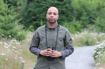 caption: Environmental scientist Armand Lucas on a birdwatching walk in Seattle's Discovery Park. 