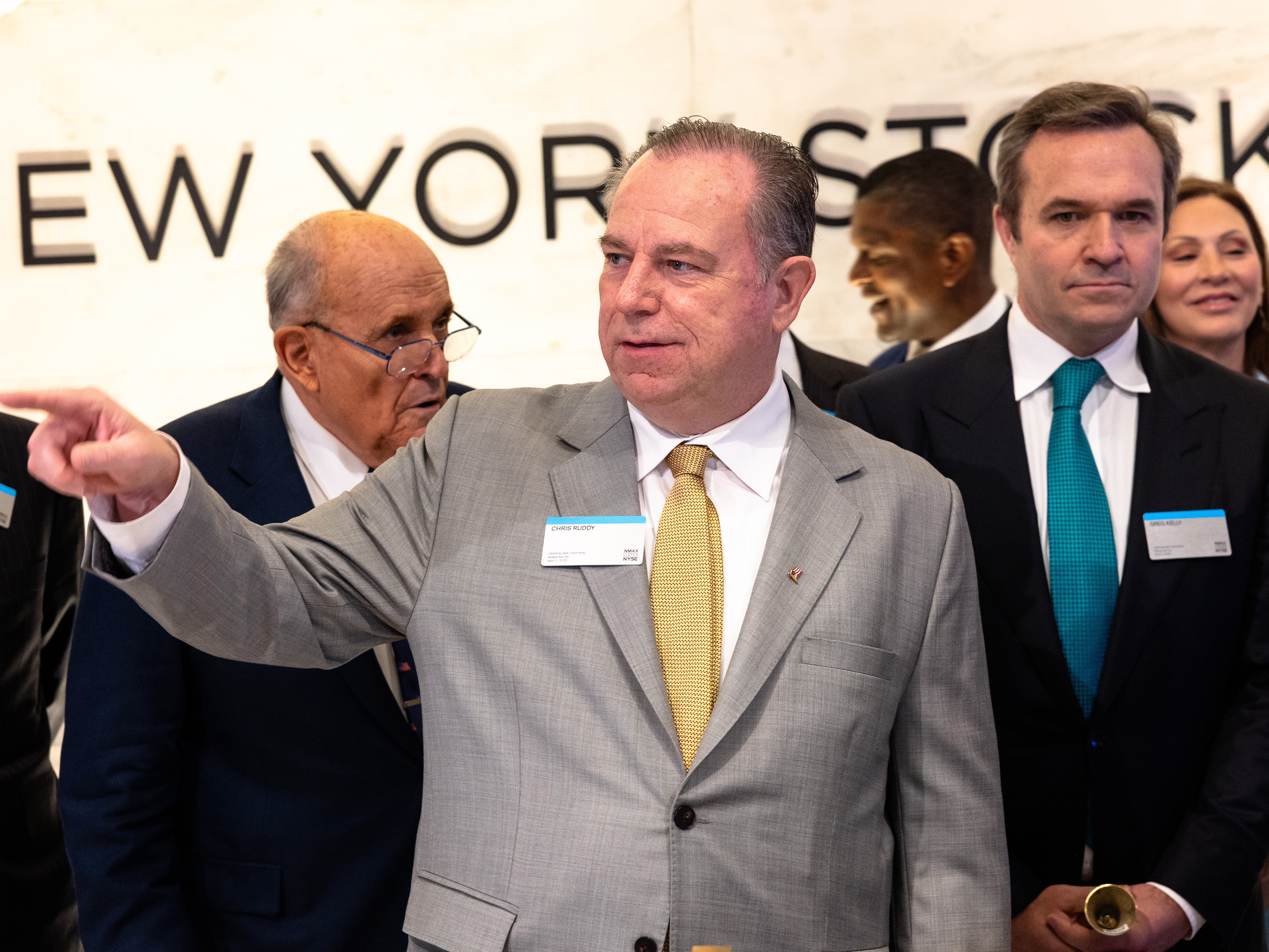caption: Chris Ruddy, the CEO of Newsmax, prepares to ring the opening bell at the New York Stock Exchange during morning trading on April 3, 2025. On Wednesday, Newsmax sued Fox, claiming it was illegally using its power to squash rival conservative networks.