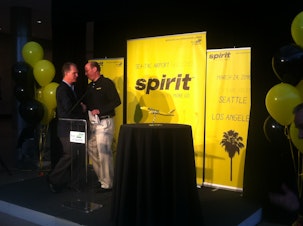 caption: Mark Kopczak from Spirit Airlines shakes hands with Port of Seattle CEO Ted Fick during the announcement Thursday of Spirit's service to Sea-Tac Airport.