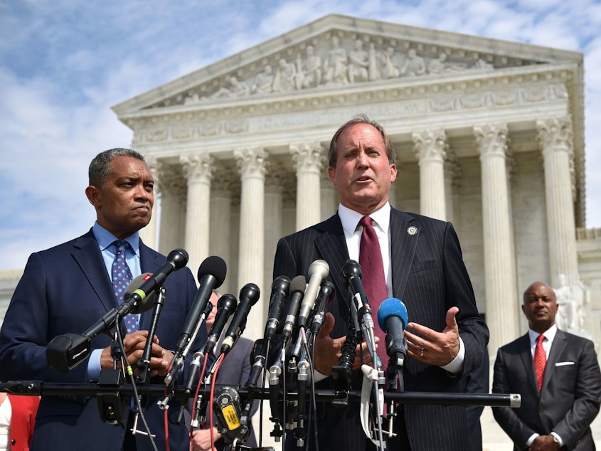 caption: District of Columbia Attorney General Karl Racine (left) and Texas Attorney General Ken Paxton speak Monday about the launch of an antitrust investigation into Google outside the Supreme Court in Washington, D.C.