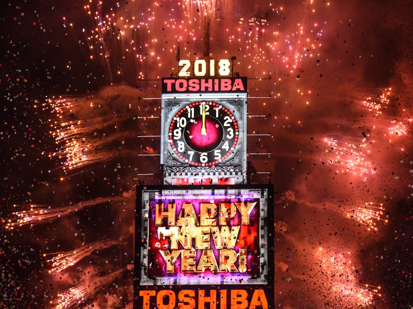 caption: Fireworks explode in Times Square on New Year's Eve on January 1, 2018 in New York City.