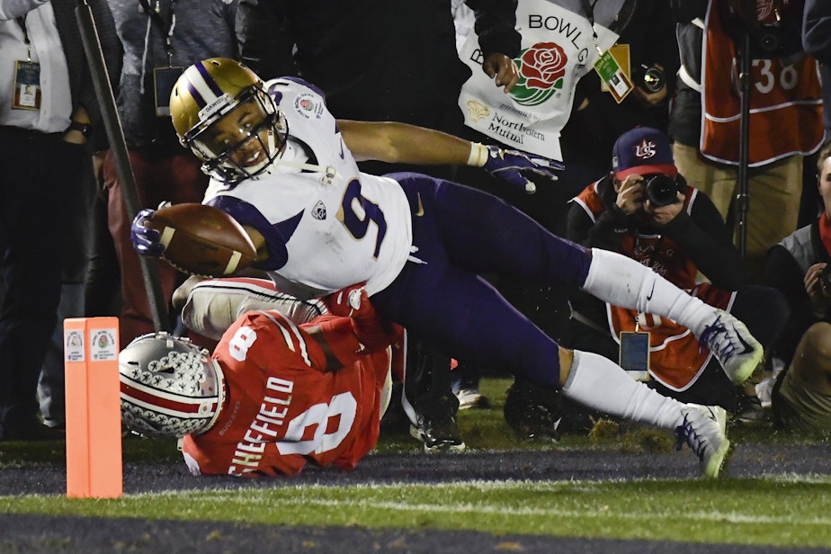 caption: Washington running back Myles Gaskin, top, scores past Ohio State cornerback Kendall Sheffield during the second half of the Rose Bowl NCAA college football game Tuesday, Jan. 1, 2019, in Pasadena, Calif. Ohio State won 28-23.