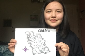 caption: Teen library volunteer Shilten Kenzhegazy holds up the map she made in a King County Library System online workshop hosted by the Federal Way Library Teen Advisory Group in May 2021.