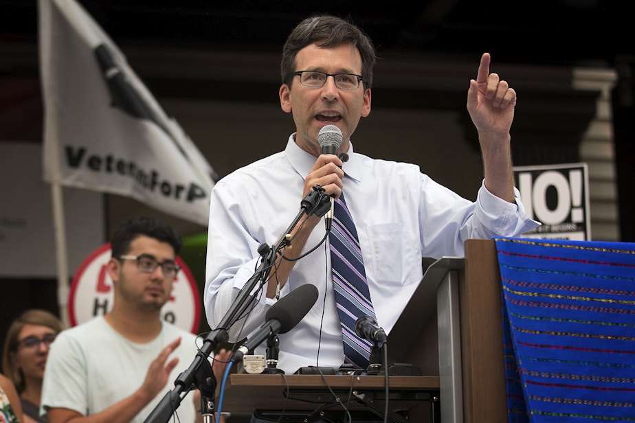 caption: FILE: Attorney General Bob Ferguson speaks during a community rally in support of DACA recipients on Tuesday, September 5, 2017, at El Centro De La Raza in Seattle. 