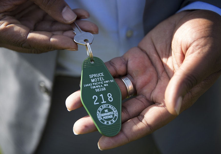 caption: De'Sean Quinn shows his prized possession: the key to one of the motels that used to dominate Tukwila's stretch of the old highway 99.