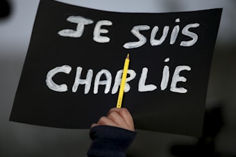 caption: In the wake of the 2015 attack in Paris, "Je Suis Charlie" became a rallying cry for demonstrators grieving the victims at the controversial French publication <em>Charlie Hebdo</em>. On Wednesday, a French court found 14 individuals guilty of supporting the massacre.