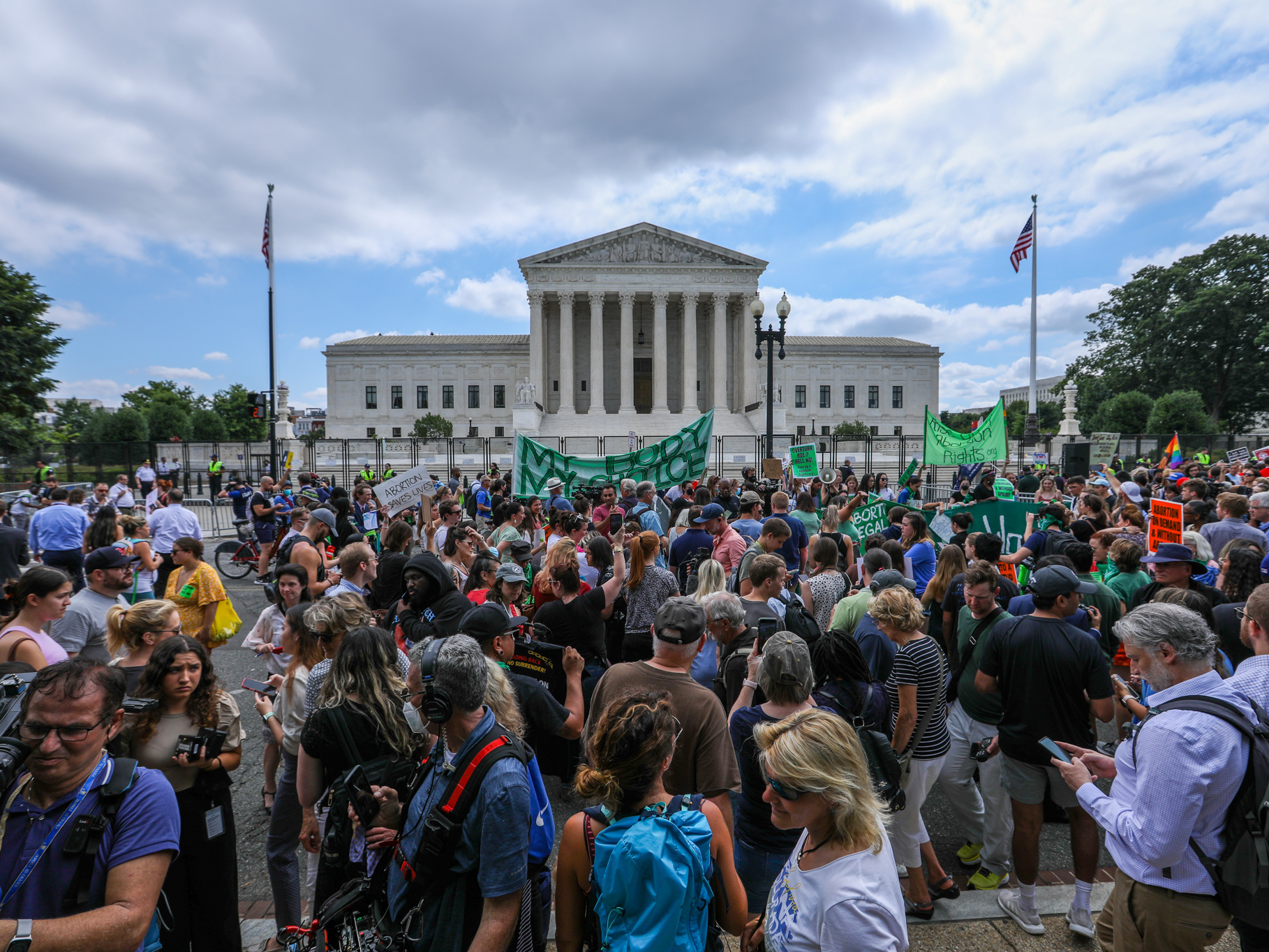 caption: Abortion rights demonstrators hold signs outside the Supreme Court in Washington, D.C., on Friday.