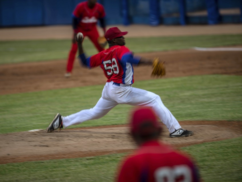 caption: Cuba's pitcher Yoanni Yera Montalvo throws the ball during a training session at the Estadio Latinoamericano in Havana last month. Cuba's losses this week in Florida to Venezuela and Canada in Olympic baseball qualifying play means the team will not compete in the Summer Games.