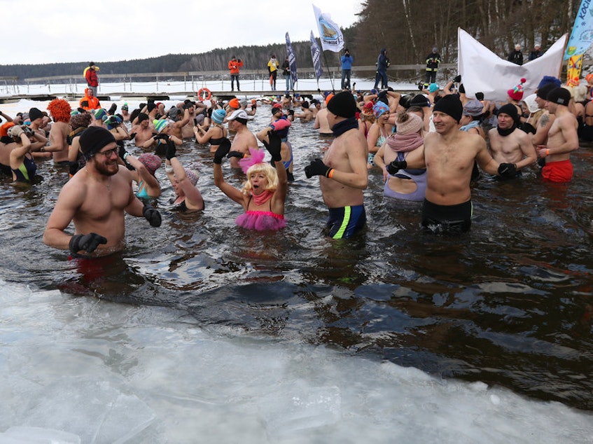 caption: Winter swimmers enjoyed an icy dip in Poland's Garczyn lake last February. Recorded air temperature was around 14 degrees Farenheit, and a large ice hole had to be cut to allow the lake bathing.CREDIT: NurPhoto/Getty Images
