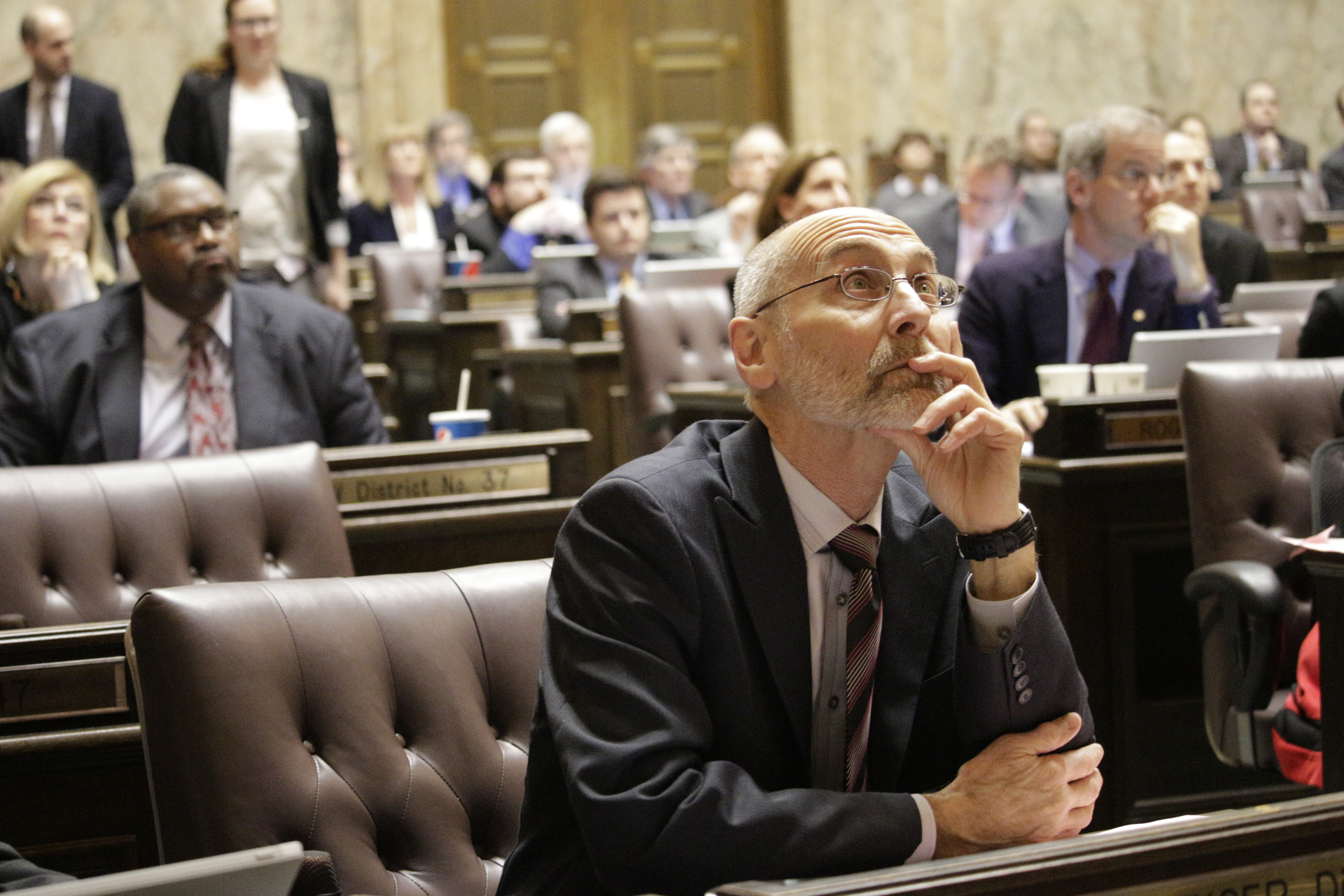 caption: In this file photo, Democratic Rep. Larry Springer watches the electronic vote board during a vote on an amendment to a bill that changes the funding source for the state's charter schools, Wednesday, March 9, 2016, in Olympia, Wash. Springer was one of just 10 Democrats in the Democratic-controlled House to support the measure that seeks to save the schools, which have been in limbo since the state Supreme Court ruled in September that the charter school system is unconstitutional. 