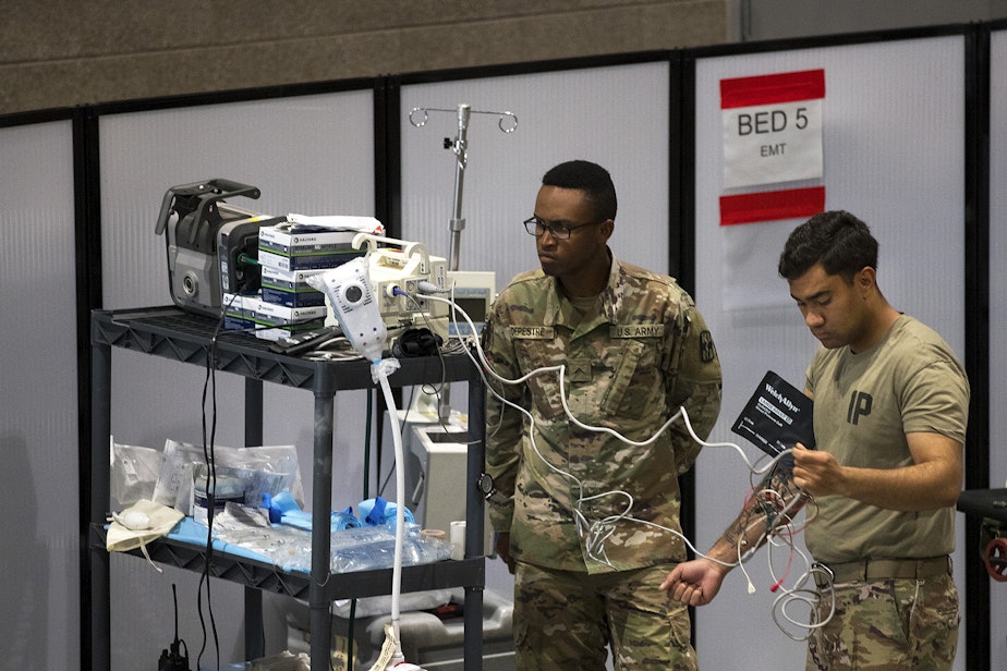 caption: U.S. Army soldiers store medical equipment in the EMT area of the military field hospital inside CenturyLink Field Event Center on Sunday, April 5, 2020, in Seattle. The 250-bed hospital for non COVID-19 patients was deployed by U.S. Army soldiers from the 627th Army Hospital from Fort Carson, Colorado, as well as soldiers from Joint Base Lewis-McChord.