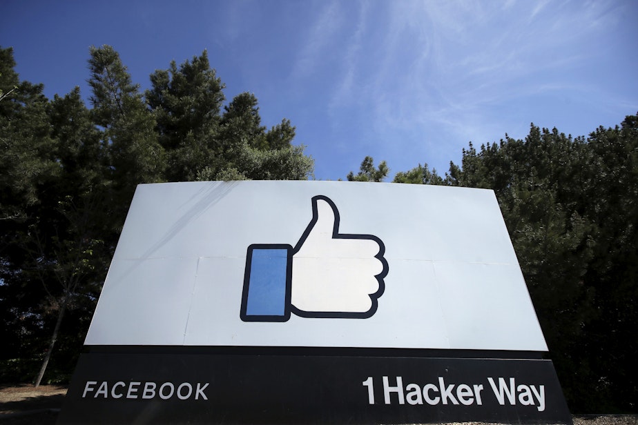 caption: The thumbs up "Like" logo is shown on a sign at Facebook headquarters in Menlo Park, California, on April 14, 2020. (Jeff Chiu/AP)