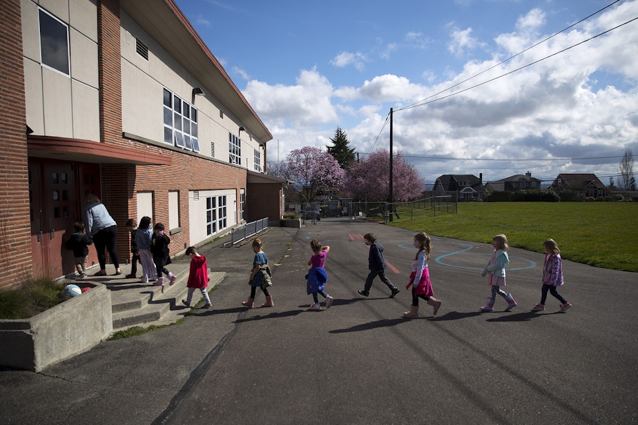 caption: Jackson Elementary kindergarteners return from recess on Tuesday, March 23, 2021, at Jackson Elementary School along Federal Avenue in Everett. With hybrid learning, students have the option to attend in-person classes two days per week.
