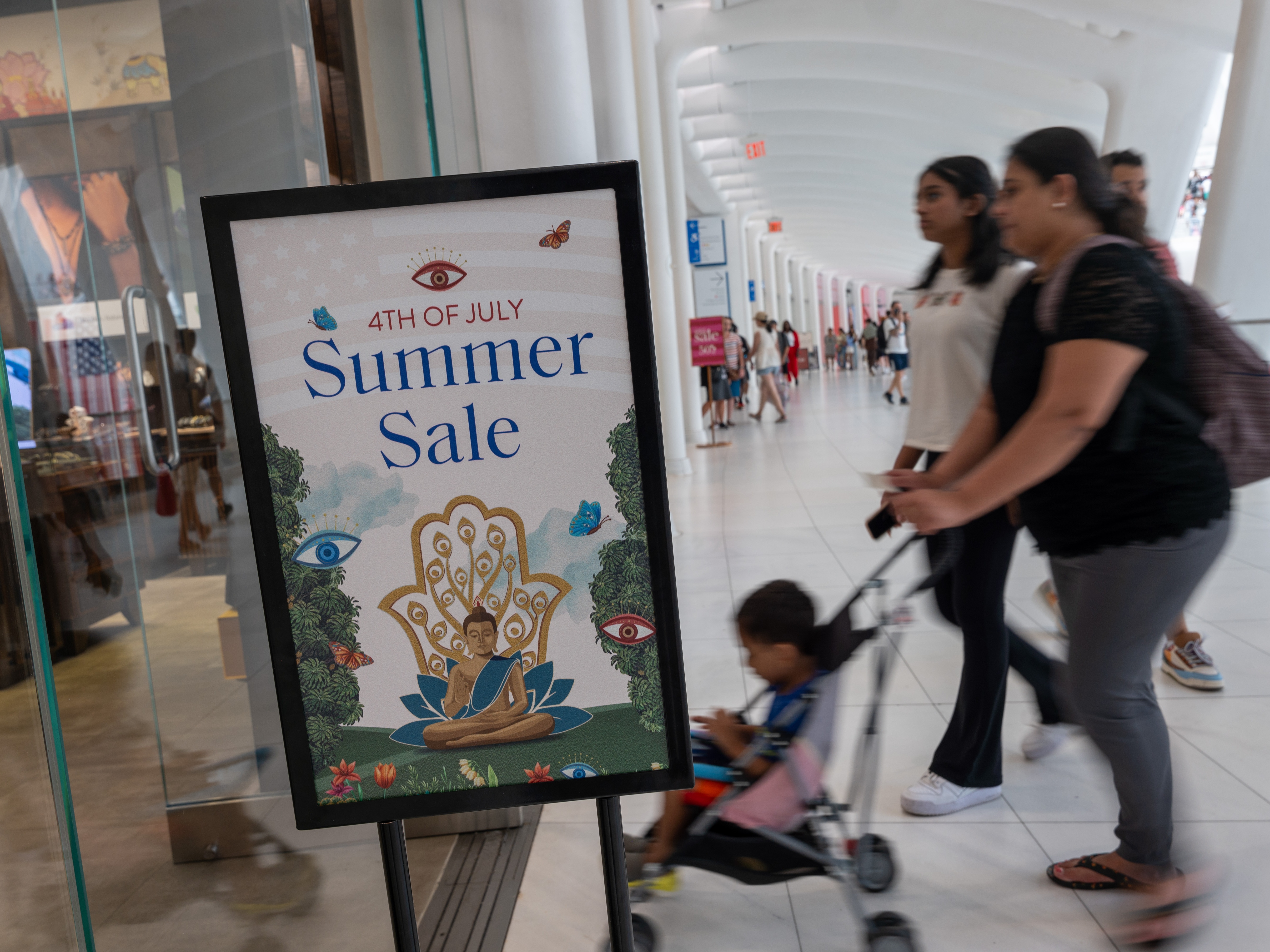 caption: People walk through a mall in Manhattan on July 5, 2024. The economy grew an annual rate of 2.8% in the July to September quarter, a solid pace of expansion.