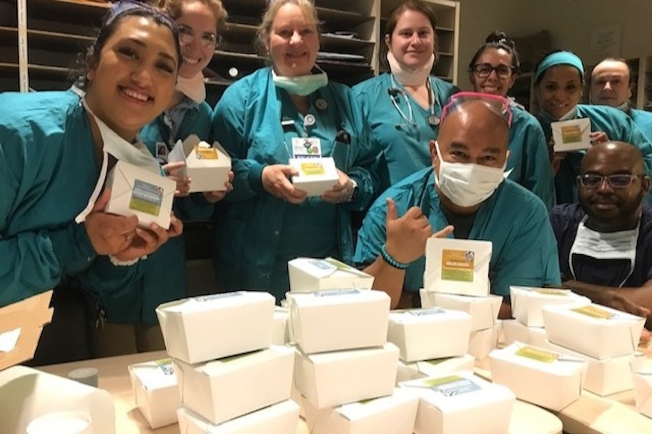 caption: Grateful healthcare workers receive meals from The Herbfarm